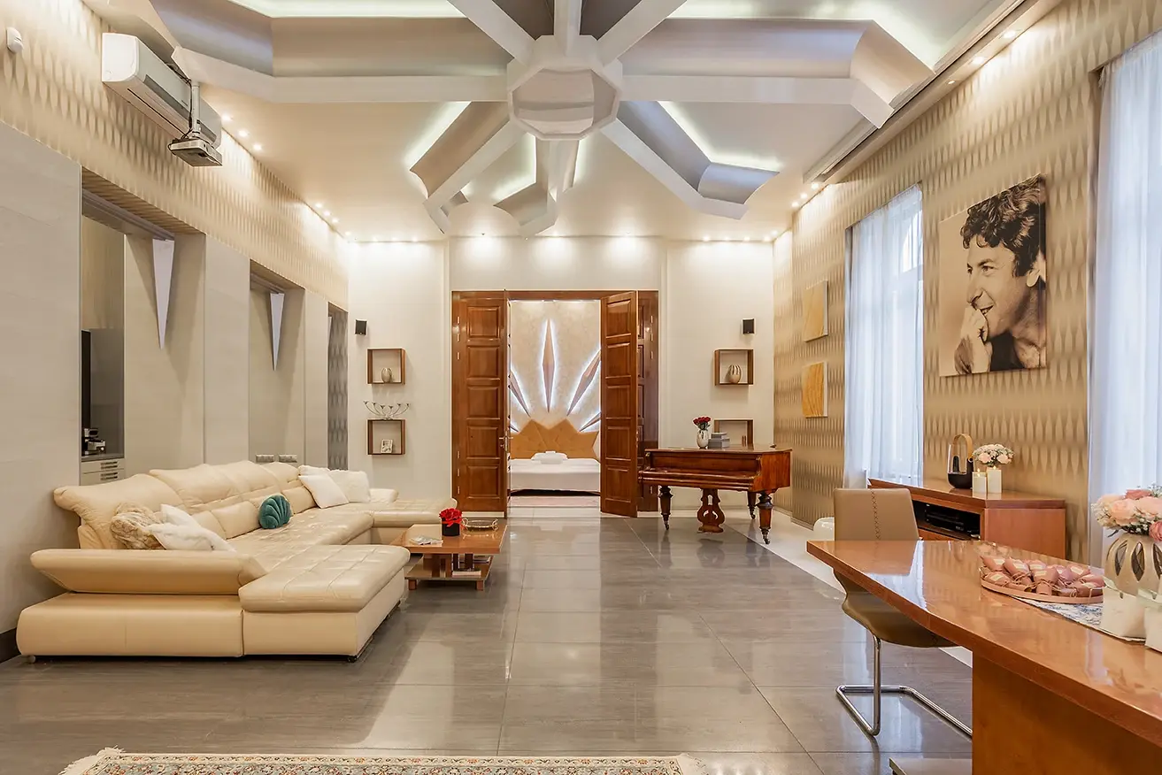 The lounge with a cream sofa under a sculpted ceiling